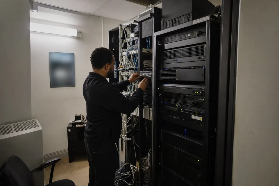 Small server closet with an aging rack server next to network equipment